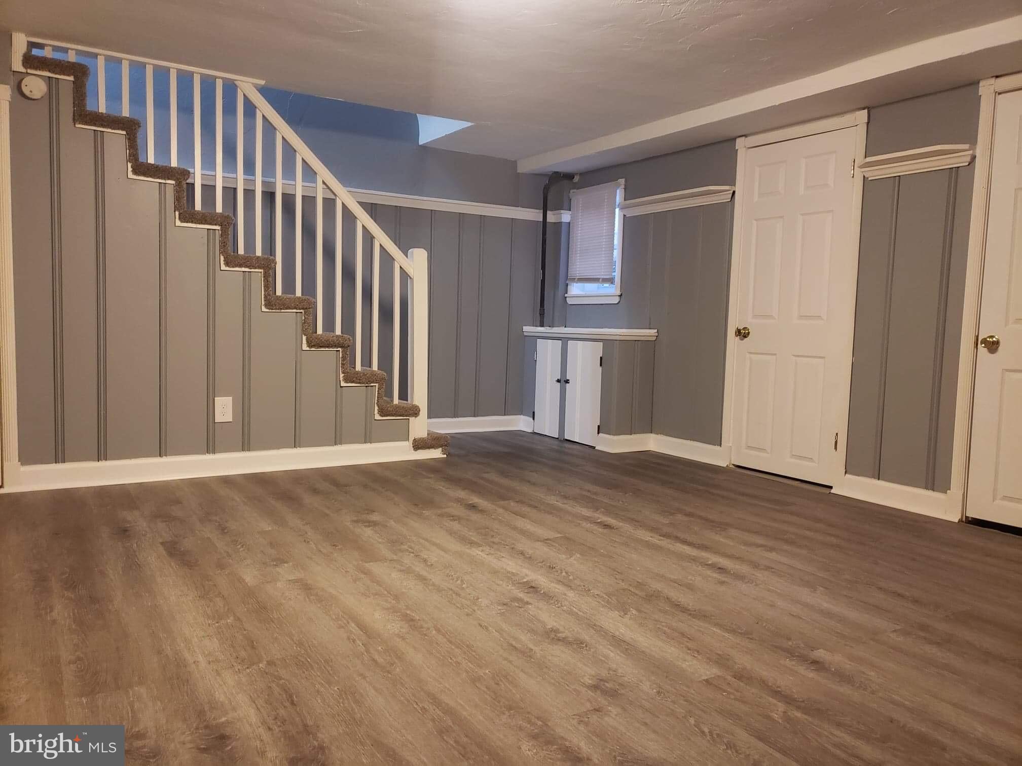 213 Westowne Road Baltimore, MD 21229 - Photo 3 of 20 a view of a livingroom with wooden floor and staircase