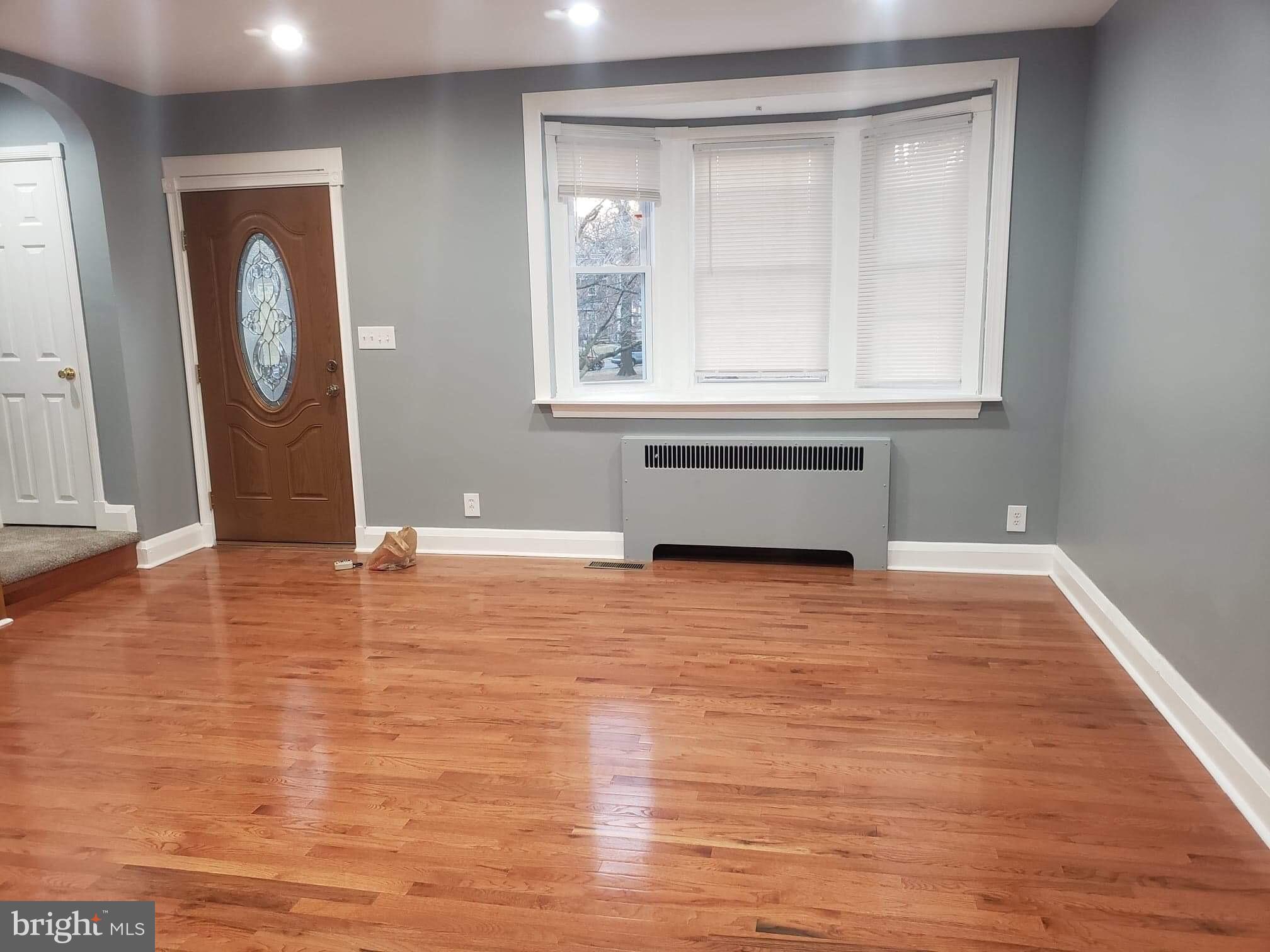 213 Westowne Road Baltimore, MD 21229 - Photo 7 of 20 a view of empty room with wooden floor and fan