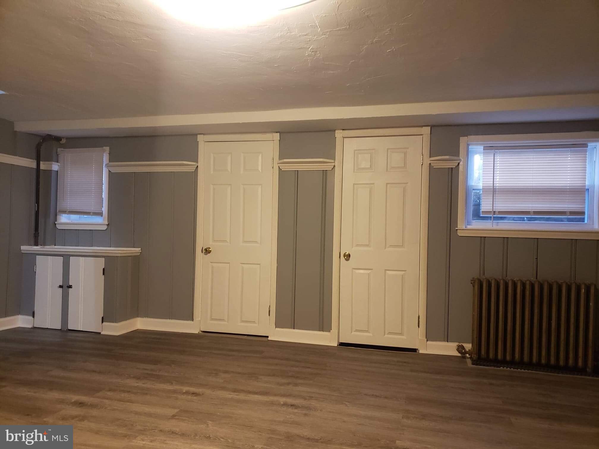 213 Westowne Road Baltimore, MD 21229 - Photo 8 of 20 a view of an empty room with wooden floor and a window