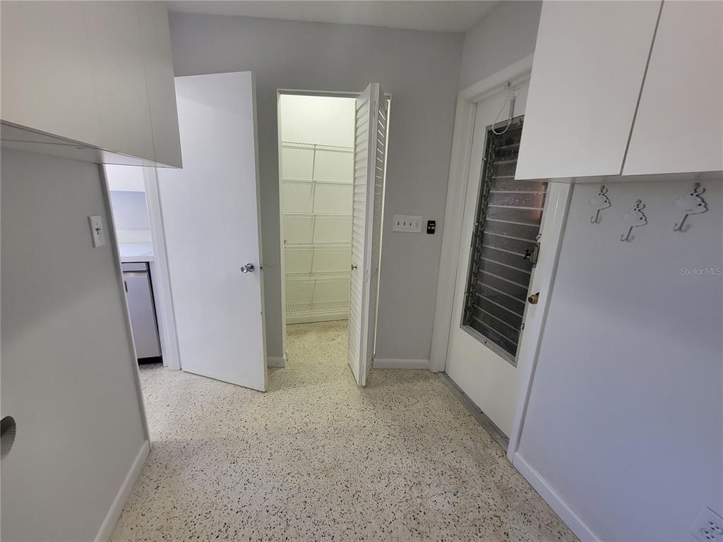 1732 Boca Raton Court Punta Gorda, FL 33950 - Photo 58 of 64 a view of hallway with stairs and a refrigerator