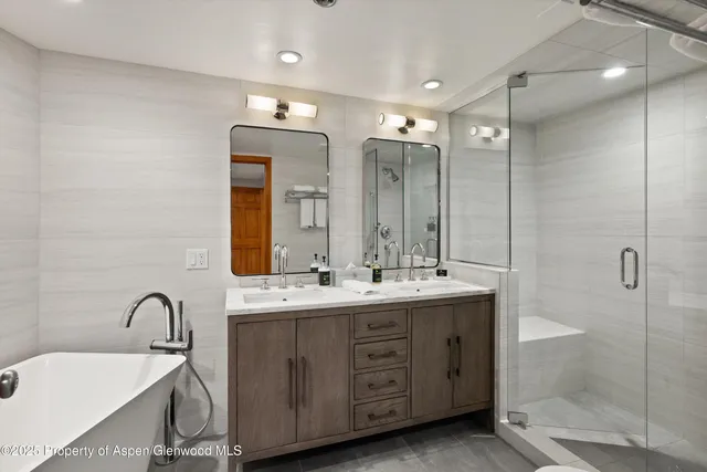 a bathroom with a double vanity sink mirror and double