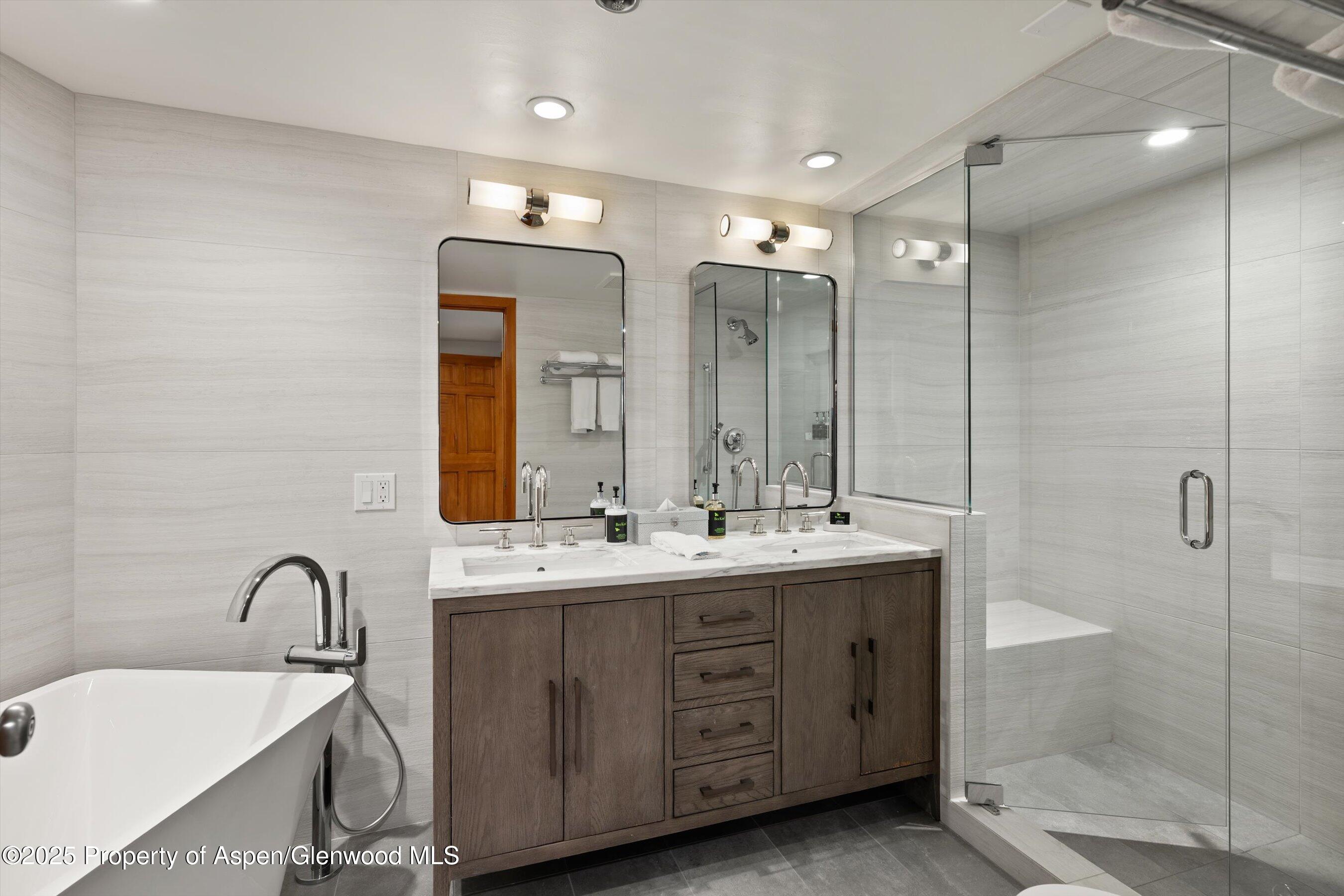 425 Wood Road, Unit 19 Snowmass Village, CO 81615 - Photo 11 of 26 a bathroom with a double vanity sink mirror and double