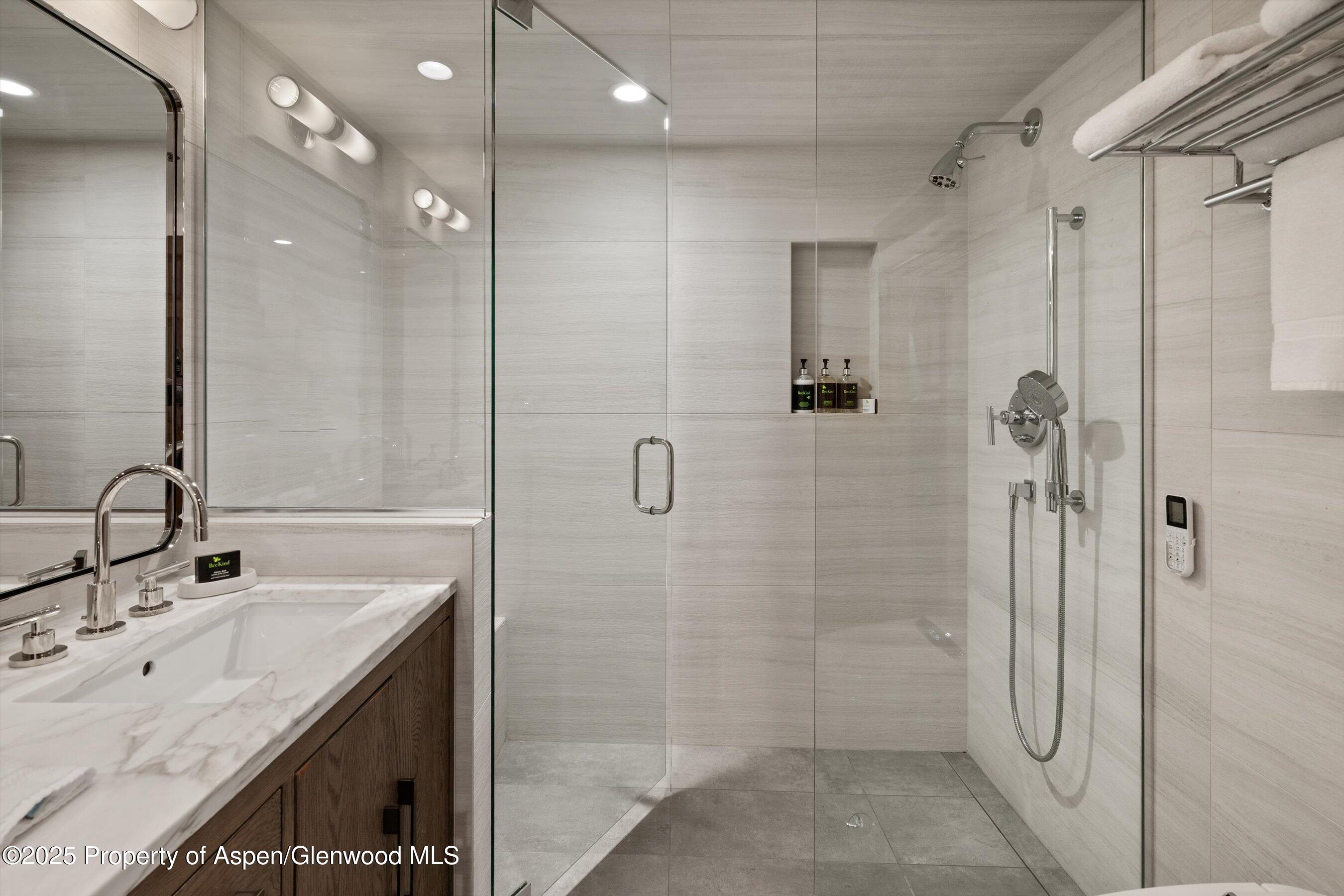 425 Wood Road, Unit 19 Snowmass Village, CO 81615 - Photo 13 of 26 a bathroom with a shower sink and mirror