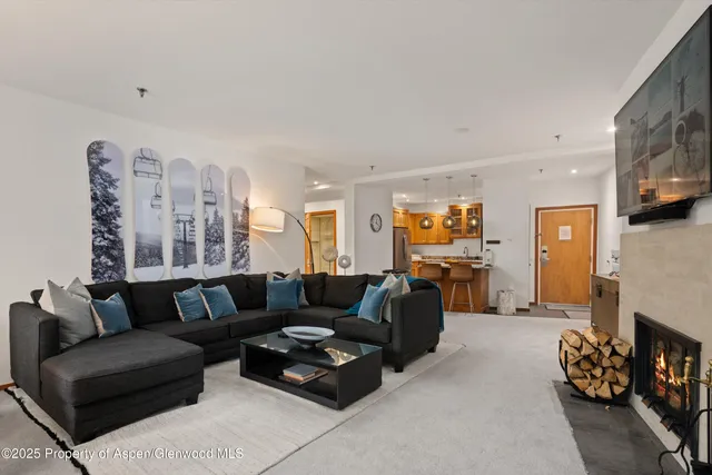 a living room with furniture a fireplace and a flat screen tv