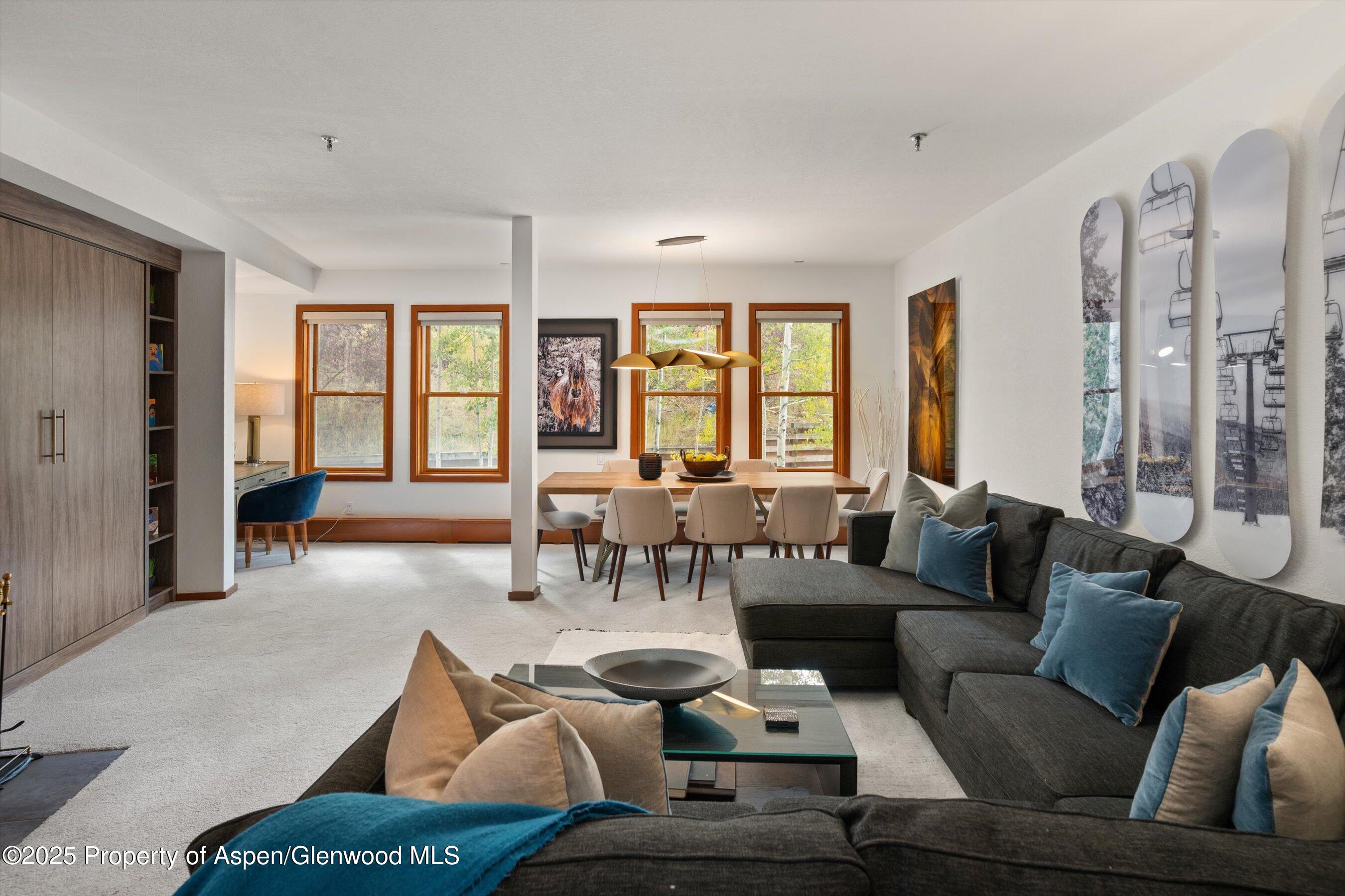 425 Wood Road, Unit 19 Snowmass Village, CO 81615 - Photo 3 of 26 a living room with furniture and large windows