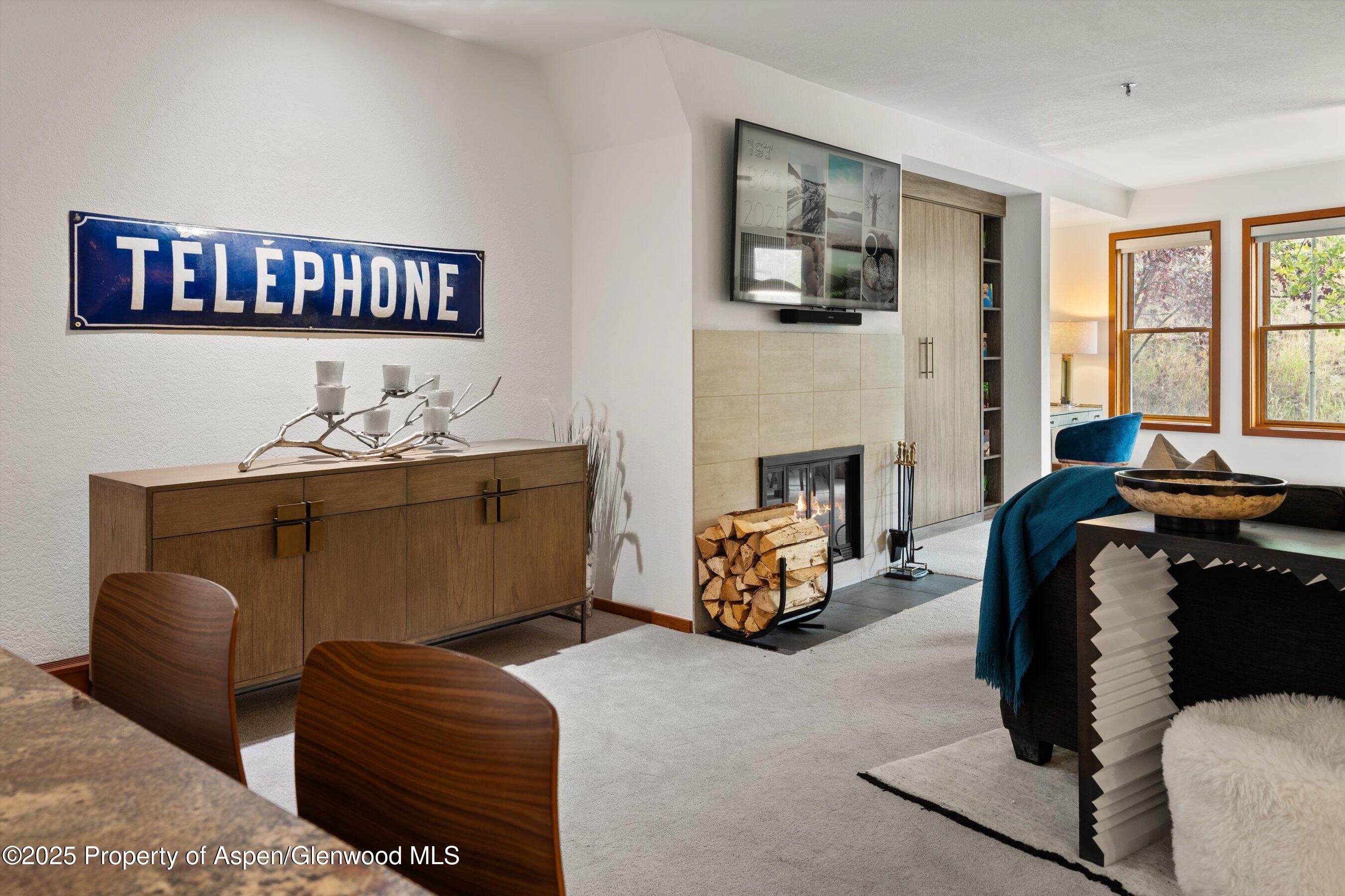 425 Wood Road, Unit 19 Snowmass Village, CO 81615 - Photo 4 of 26 a bedroom with furniture and a fireplace