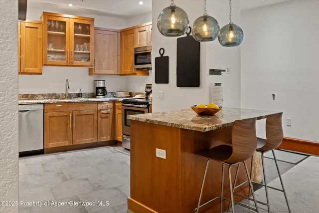 a kitchen with stainless steel appliances granite countertop a stove and cabinets
