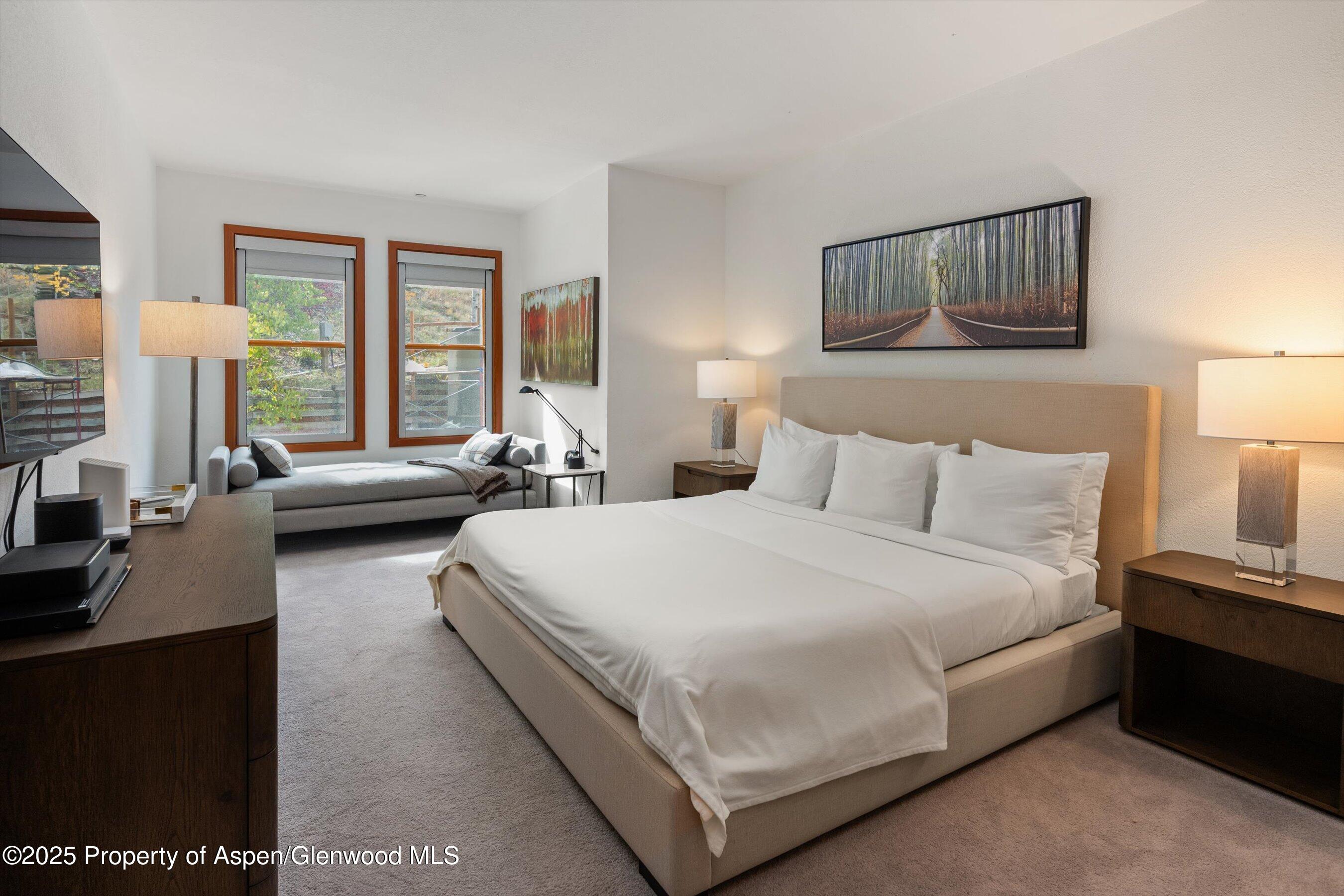 425 Wood Road, Unit 19 Snowmass Village, CO 81615 - Photo 8 of 26 a bedroom with bed and a night stand