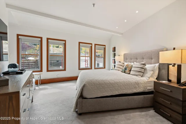 a spacious bedroom with a bed and a cabinets