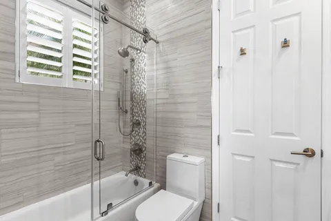 a bathroom with a toilet and shower