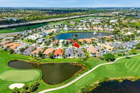 an aerial view of a golf course with a lake view