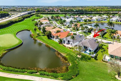 an aerial view of residential houses with outdoor space and river
