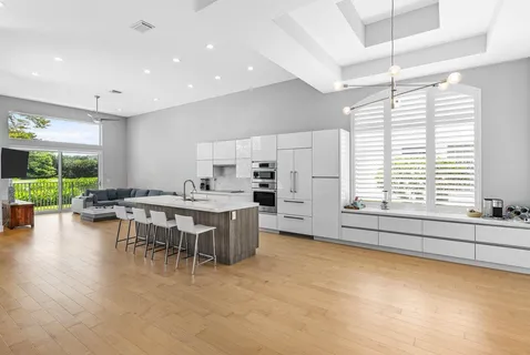 a kitchen with a table chairs and a refrigerator