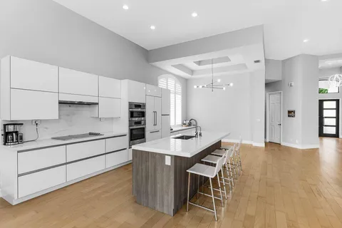 a kitchen with stainless steel appliances kitchen island granite countertop a sink and cabinets