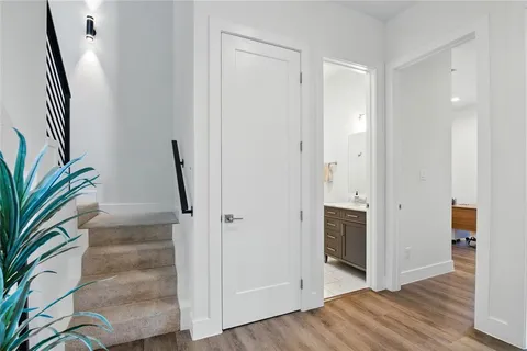 an entryway with wooden floor and a hallway