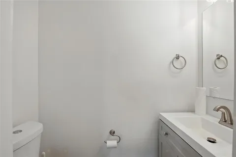 a bathroom with a sink toilet and vanity