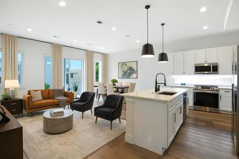 a kitchen with stove a sink and a refrigerator