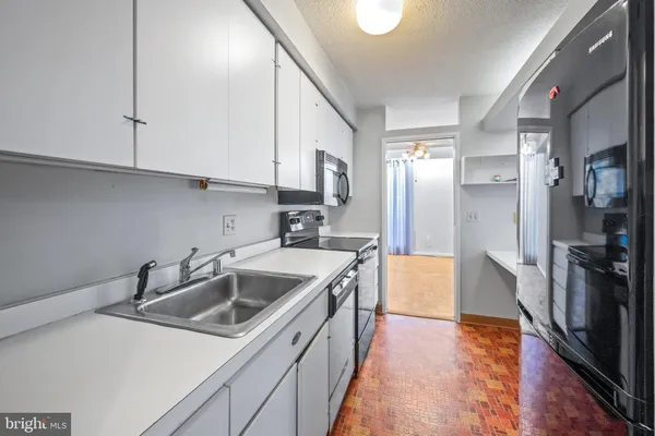 a kitchen with a sink stove and refrigerator