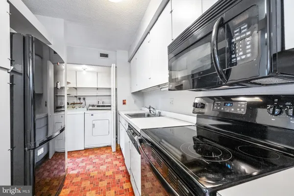 a kitchen with a stove and a refrigerator