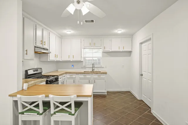 a kitchen with stainless steel appliances granite countertop a stove refrigerator sink and cabinets