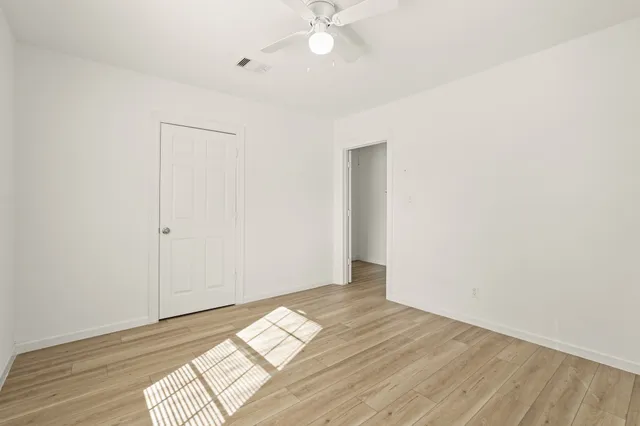 a view of a livingroom with wooden floor and white walls