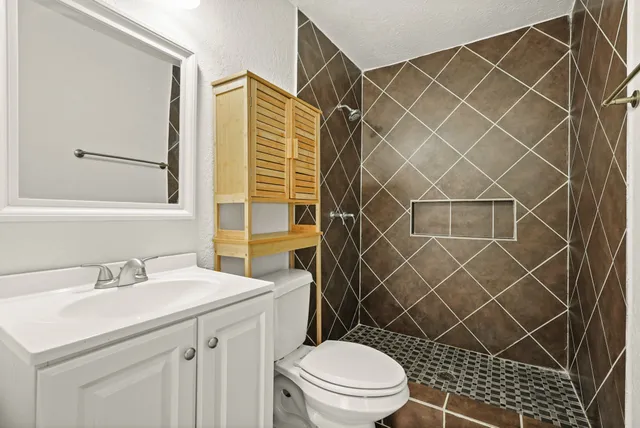 a bathroom with a sink toilet and shower