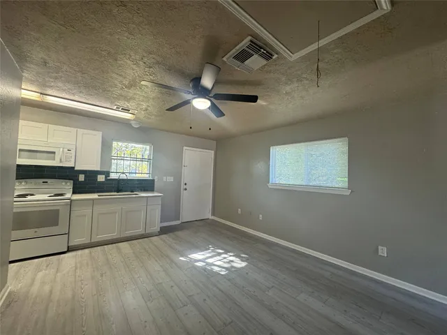 a kitchen with cabinets and window