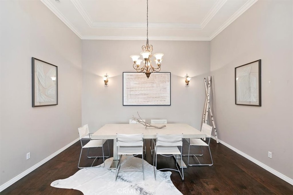 1486 Valley Drive Norco, CA 92860 - Photo 13 of 66 a dining room with wooden floor a chandelier a wooden table and chairs