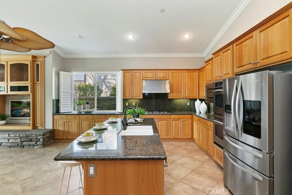 1486 Valley Drive Norco, CA 92860 - Photo 16 of 66 a kitchen with stainless steel appliances granite countertop a sink a stove and a refrigerator
