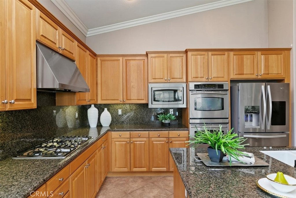 1486 Valley Drive Norco, CA 92860 - Photo 19 of 66 a kitchen with granite countertop a stove a sink and a microwave