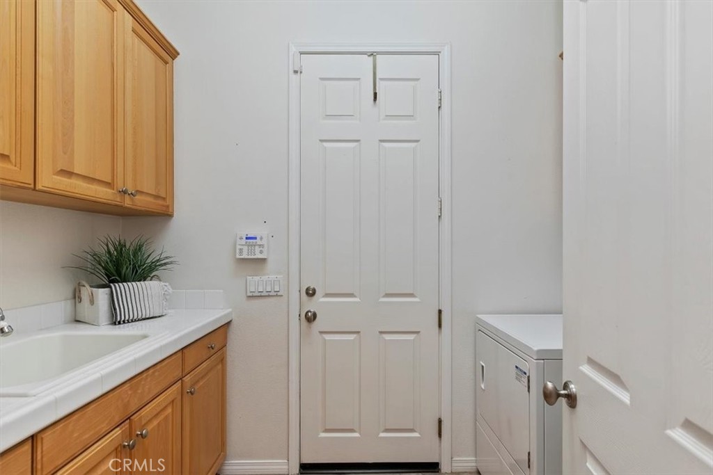 1486 Valley Drive Norco, CA 92860 - Photo 25 of 66 a bathroom with a sink a potted plant and wooden floor