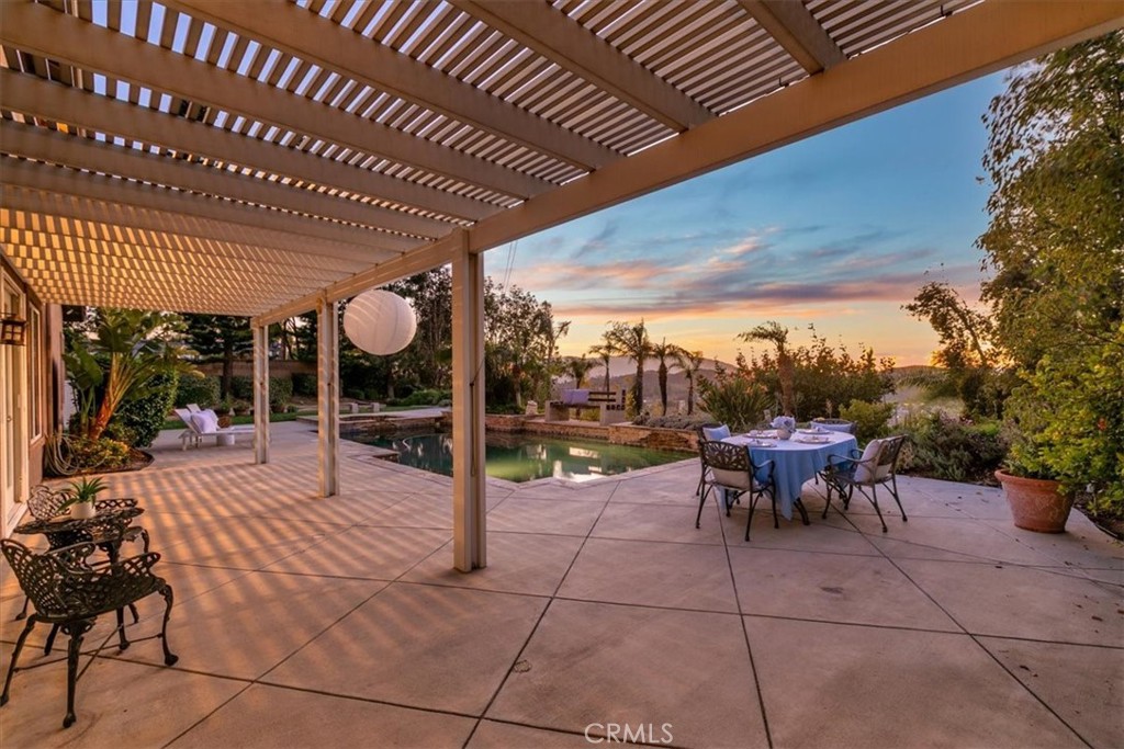 1486 Valley Drive Norco, CA 92860 - Photo 49 of 66 a view of a patio with table and chairs with wooden floor and fence