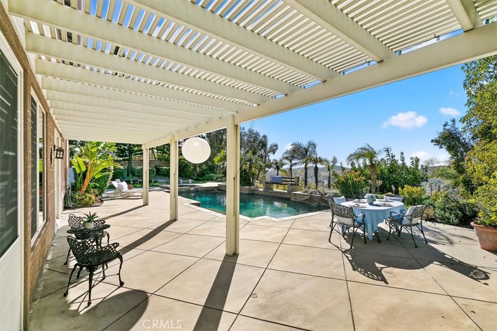 1486 Valley Drive Norco, CA 92860 - Photo 50 of 66 a view of a patio with a table and chairs and potted plants