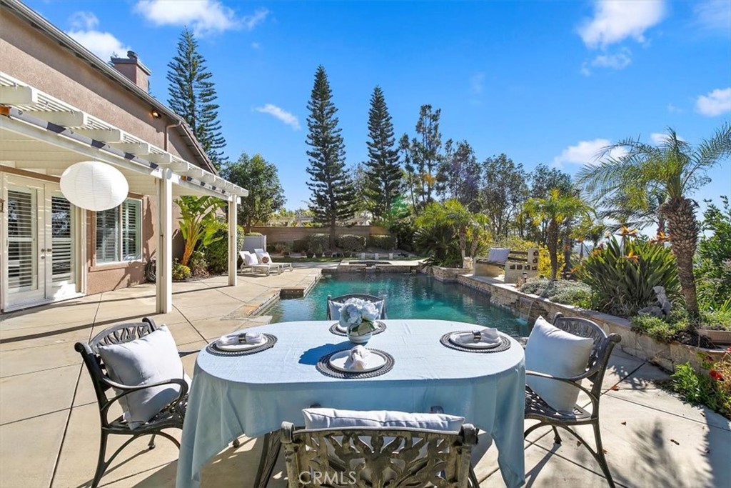 1486 Valley Drive Norco, CA 92860 - Photo 52 of 66 a view of a patio with table and chairs and potted plants