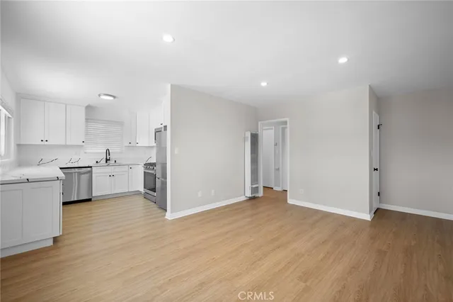 a view of a kitchen with wooden floor