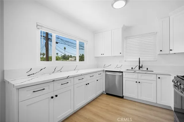 a kitchen with sink cabinets and window
