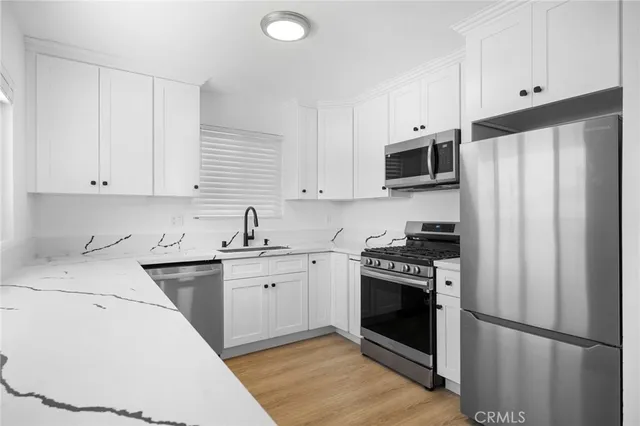 a kitchen with a sink stove and refrigerator