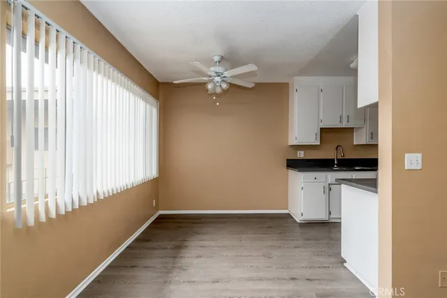 a view of kitchen with granite countertop cabinets and window