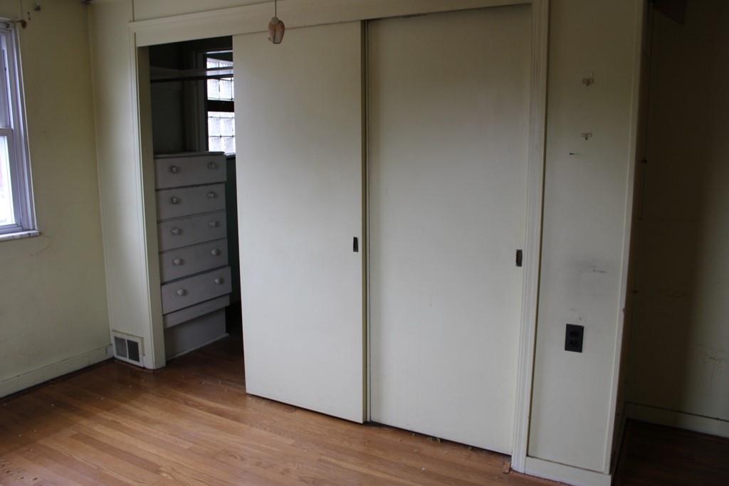 825 Liberty Street Duquesne, PA 15110 - Photo 13 of 25 an empty room with wooden floor closet and windows