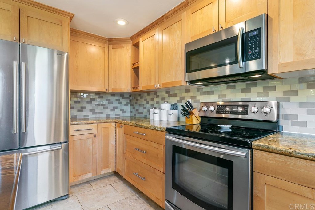 1005 Woodcreek Road Fallbrook, CA 92028 - Photo 14 of 32 a kitchen with stainless steel appliances a stove microwave and refrigerator
