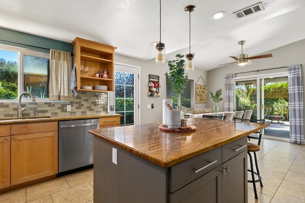 1005 Woodcreek Road Fallbrook, CA 92028 - Photo 15 of 32 a kitchen with center island table and chairs