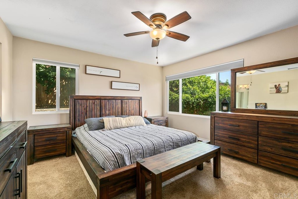 1005 Woodcreek Road Fallbrook, CA 92028 - Photo 16 of 32 a bedroom with a bed and a large window with the outer view