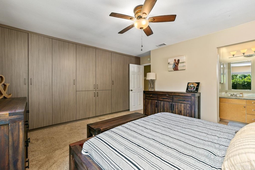1005 Woodcreek Road Fallbrook, CA 92028 - Photo 17 of 32 a bedroom with a bed dresser and a large window