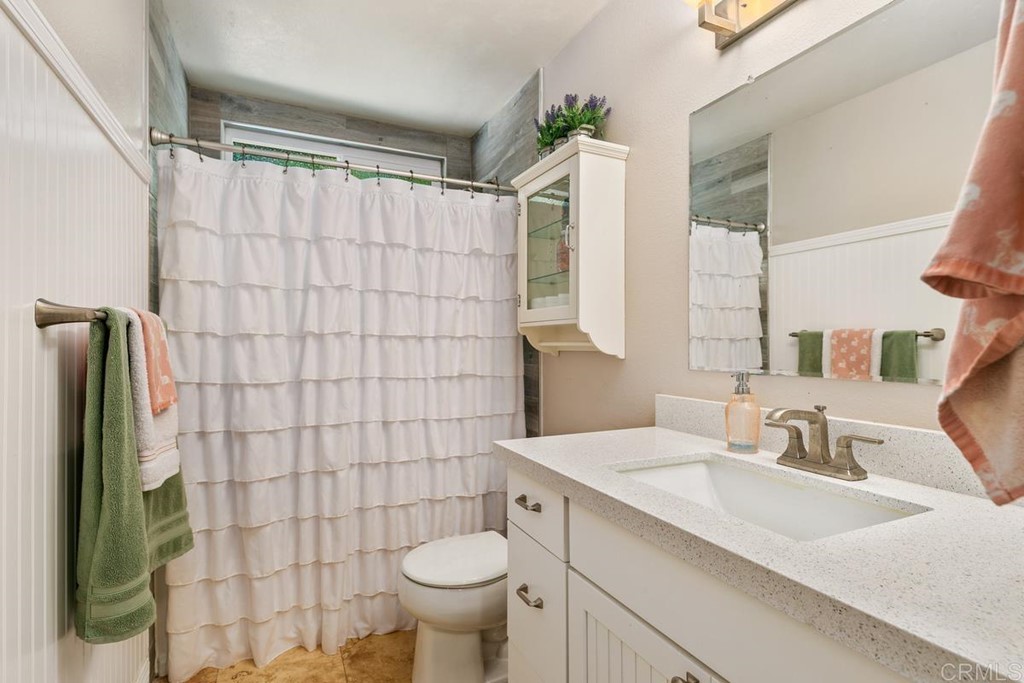 1005 Woodcreek Road Fallbrook, CA 92028 - Photo 25 of 32 a bathroom with a sink toilet and shower