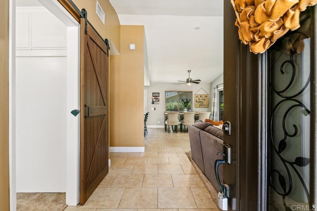 1005 Woodcreek Road Fallbrook, CA 92028 - Photo 5 of 32 a very nice looking room with a large tree and wooden floor