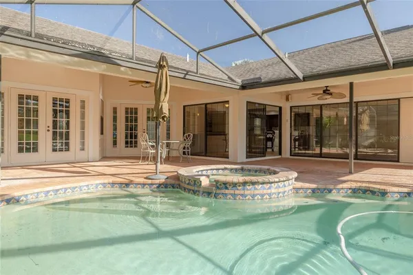 a swimming pool with patio outdoor seating and yard