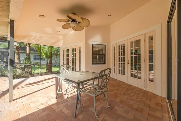 a dining room with furniture a chandelier and wooden floor