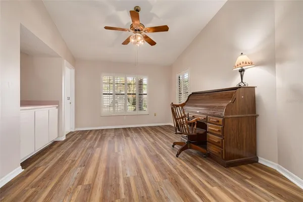 a view of room with wooden floor and windows