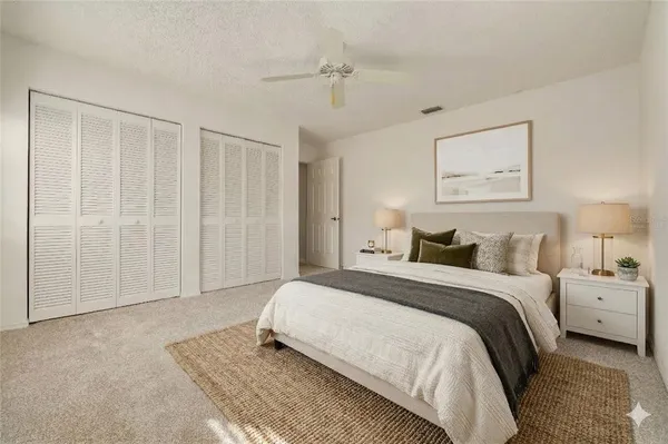 a spacious bedroom with a bed and a chandelier