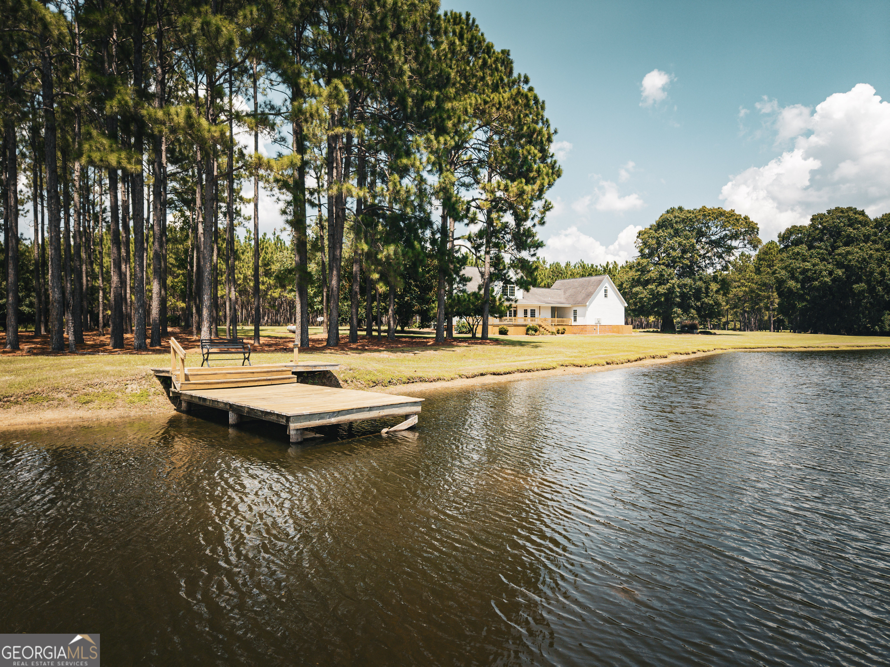 1576 Chula Brookfield Road Tifton, GA 31794 - Photo 17 of 79 a view of swimming pool with lawn chairs and wooden fence